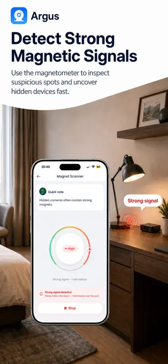 The Argus magnet scanner dial reading high over a small black device on a desk, with a strong-signal warning.